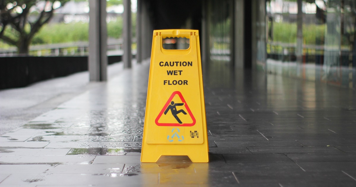 Caution Wet Floor sign on wet surface outdoors