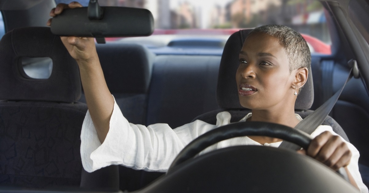 Driver checks rearview mirror